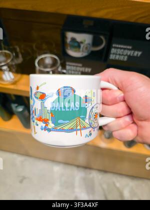 DALLAS, TX, USA - JULY 13, 2026: A hand holds a Starbucks mug featuring a colorful illustration of Dallas, displayed in a store setting. The mug showc Stock Photo