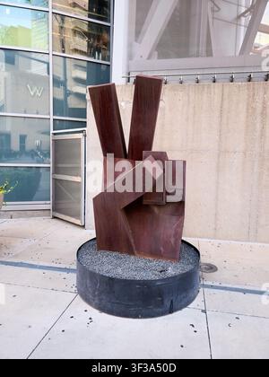 DALLAS, TX, USA - JULY 13, 2026: A modern abstract metal sculpture is displayed outside a building in downtown Dallas. The sculpture features geometri Stock Photo