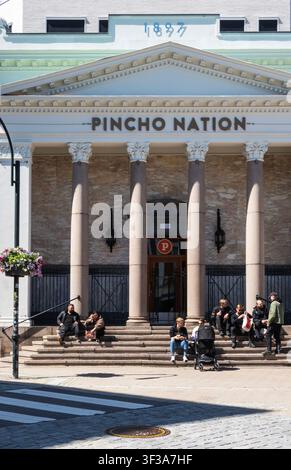 Pincho Nation Restaurant, Kristiansand, Norway, June 2026 with people sitting on the steps outside Stock Photo