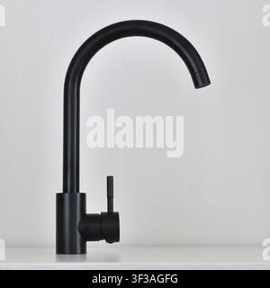 Black single-lever mixer tap on light background Stock Photo