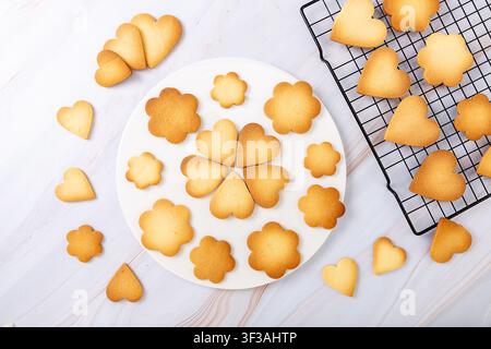 Mixed assortment of handmade crispy shortbread cookies in flower and heart shapes Stock Photo