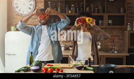 Happy black couple having fun in kitchen Stock Photo