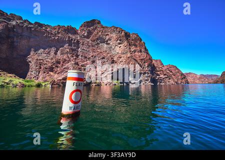 Flat Wake Buoy on Colorado River with Rocky Cliffs and Calm Water near Willow Beach Stock Photo