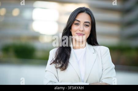 Portrait of Woman Wearing White Blazer in an Outdoor Setting Stock Photo