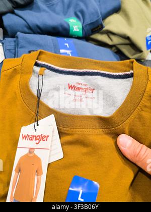 PLANO, TX, USA - JULY 19, 2026: Wrangler T-shirts are neatly displayed at a Costco retail store, highlighting various sizes and colors. Wrangler is kn Stock Photo