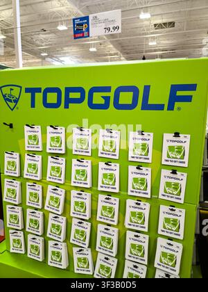 PLANO, TX, USA - JULY 19, 2026: Topgolf gift cards are displayed in a vibrant green stand inside a Costco warehouse. Costco offers a variety of produc Stock Photo