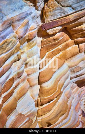 Layered Sandstone Rock Texture with Vibrant Desert Colors and Erosion Patterns Stock Photo