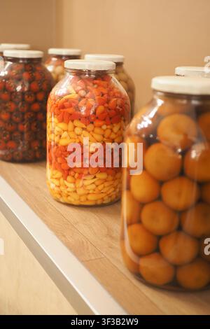 Colorful jars with various food items on a shelf Stock Photo