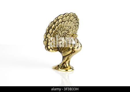 Brass Peacock ornament on a white background Stock Photo