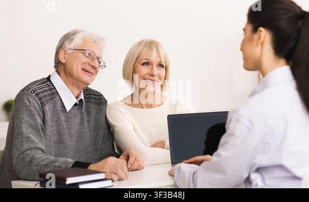 Senior couple visiting doctor and discussing their health Stock Photo