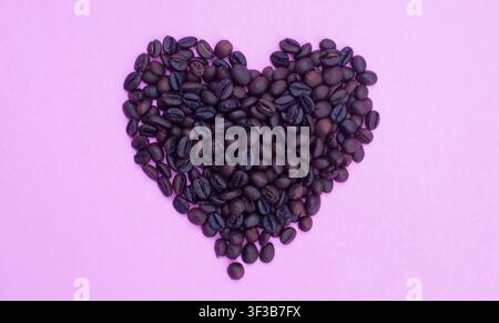 Heart Shape Coffee Beans on Pink Background for Romantic Coffee Concept Stock Photo