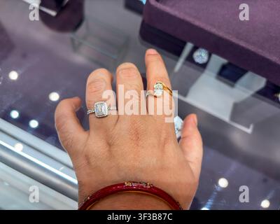 Woman Trying lab grown Diamond Engagement Rings At Premium Jewelry Boutique Display Stock Photo