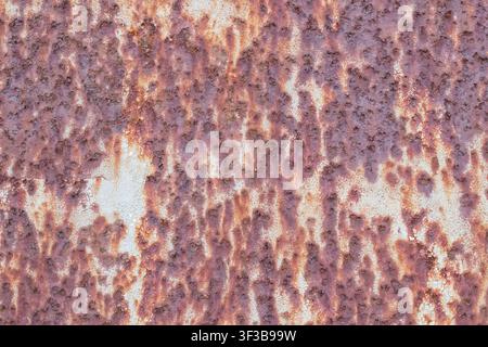 Abstract rust texture in purple and pink tones on an old weathered metal surface, full frame Stock Photo