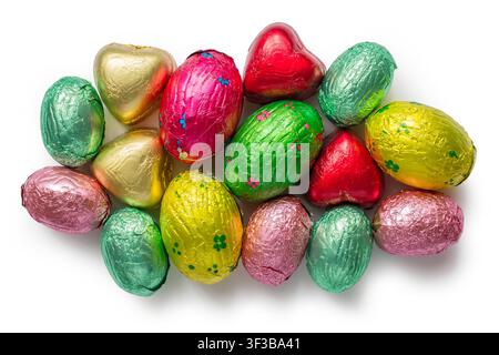 Set of chocolate candies in multi-colored foil on a white background. Multi-colored chocolate eggs. Stock Photo