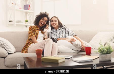 Woman overhearing her girlfriend mobile phone talk Stock Photo