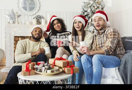 Friends watching movie and having fun at Christmas eve. Stock Photo