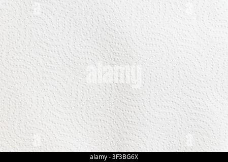 White embossed paper towel texture background with copy space. Minimalist paper surface banner featuring a decorative embossed wave pattern. Stock Photo