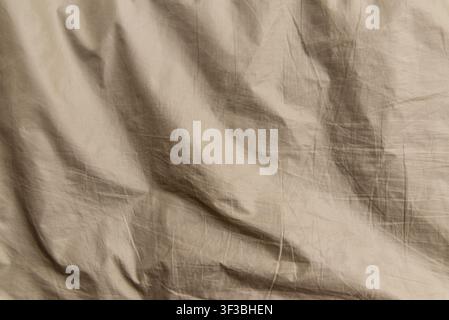 Beige striped fabric texture background with copy space. Minimalist khaki micro-striped textile banner featuring soft natural folds. Stock Photo