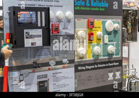 Bangkok, Thailand - July 22, 2026: Smoke detectors, manual pull station, and wiring diagram displayed on a fire alarm system board at International En Stock Photo