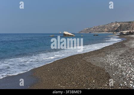 Petra tou Romiou pebble beach and coastal rock formations on a clear day, Cyprus Stock Photo