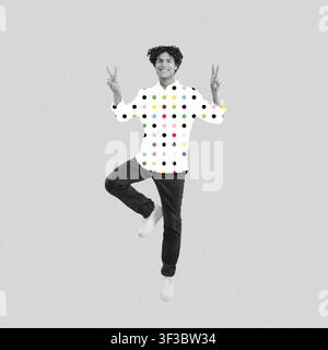 Happy Young Man With Curly Hair Posing Playfully In Polka Dot Shirt, Home Concept Stock Photo