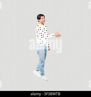 Smiling Young Asian Man Shaking Hands, Casual Attire, Business Concept Stock Photo