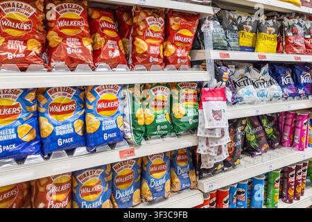 Shelves filled with packaged potato chips in supermarket. London, UK, 3 March 2024 Stock Photo
