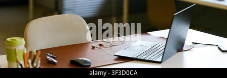 Modern Office Desk Featuring Laptop for Remote Work Setup Stock Photo