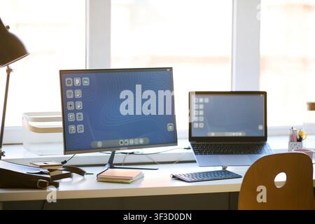 Home Office Workspace Featuring Desktop Computer and Laptop Stock Photo