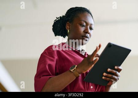 Black Adult Woman Using Tablet for Digital Communication Stock Photo