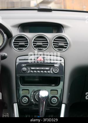 Car dashboard interior with central console and air conditioning vents. Automotive technology and driving control panel including audio system, gear s Stock Photo