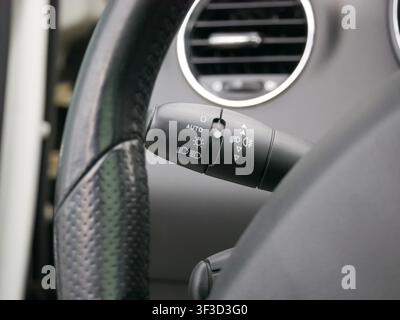 Car headlight control stalk on steering column. Indicator switch for vehicle lighting system. Automotive interior design component for safe driving an Stock Photo