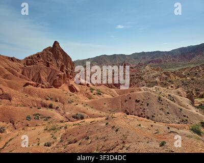 Fairy Tale Canyon. Unique badlands landscape with eroded cliffs, colorful geological layers and rugged terrain under blue sky in Central Asia. Stock Photo