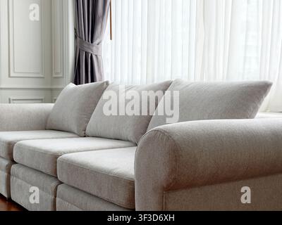 Close-up of comfortable beige fabric couch in living room corner Stock Photo
