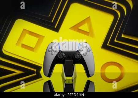 July 23, 2026, Odessa, Ukraine.  Sony PS5 controller in foreground with a large glowing PlayStation plus sign on the background. Stock Photo