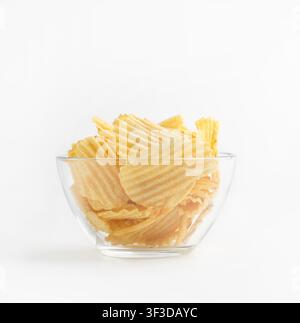 Ribbed chips in glass plate isolated on white background Stock Photo