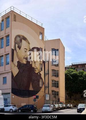Large mural of two men on residential building in Palermo Stock Photo