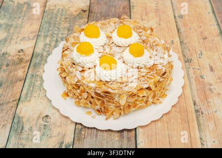 Sliced Passion Fruit Cheesecake with Glossy Fruit Glaze and Biscuit Crust on Gold Board Stock Photo