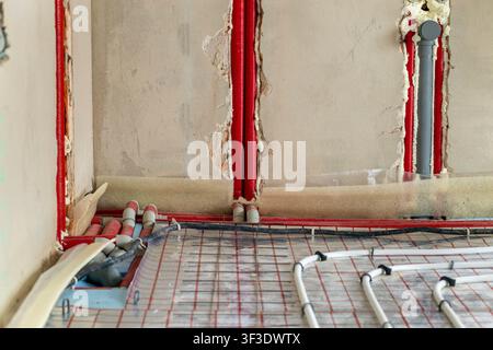 Radiant floor heating system with plastic pipes secured to insulation panels before concrete placement. Energy saving technology and residential Stock Photo
