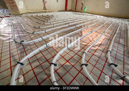 Radiant heating system prepared for concrete covering. Organized pipe layout, modern engineering and energy-efficient residential construction Stock Photo