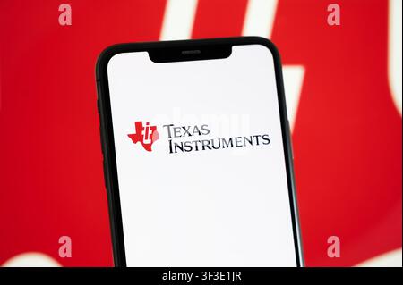 Paris, France - July 23, 2026 : A smartphone displaying the logo of Texas Instruments held in front of a screen displaying company branding. Stock Photo