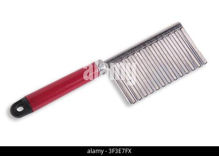 Crinkle cutter knife with wavy stainless steel blade and red handle on white background Stock Photo