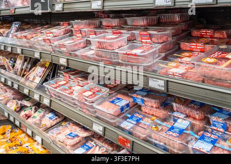 Packaged raw meat on display shelves in supermarket. London, UK, 3 March 2024 Stock Photo