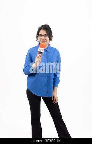 Active female speaker holding small microphone giving speech Stock Photo