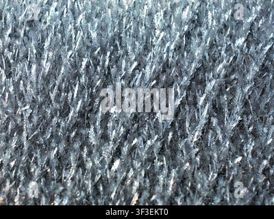 This closeup image showcases a dense formation of sparkling ice crystals, creating a textured and shimmering surface Stock Photo