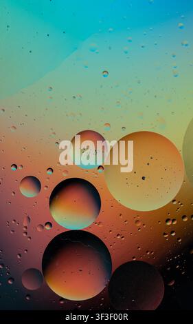 Oil and water mixing, forming colorful spherical bubbles and texture with vibrant gradients Stock Photo