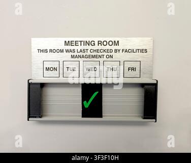 A meeting room facilities check sign with green tick,illustrating office management and debate over modern physical,remote MS Teams and hybrid working Stock Photo