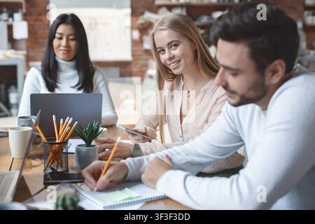 Close up of young multiracial business team working on project Stock Photo