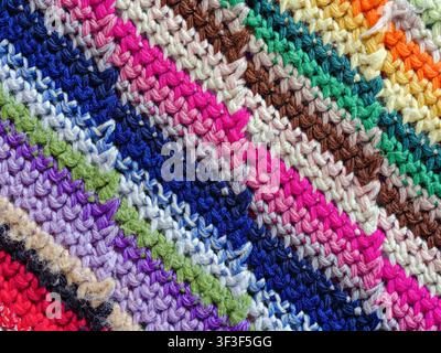 Detail of the diagonal patterns of yarn in a colorful blanket Stock Photo