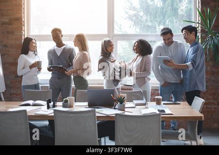 Friendly business team talking while having break Stock Photo